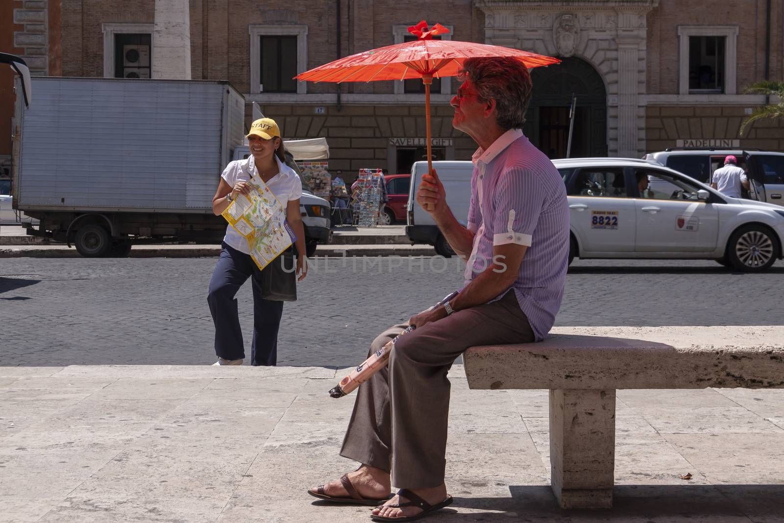 Rome, Italy - June 28, 2010: A street vendor of umbrellas by alvarobueno