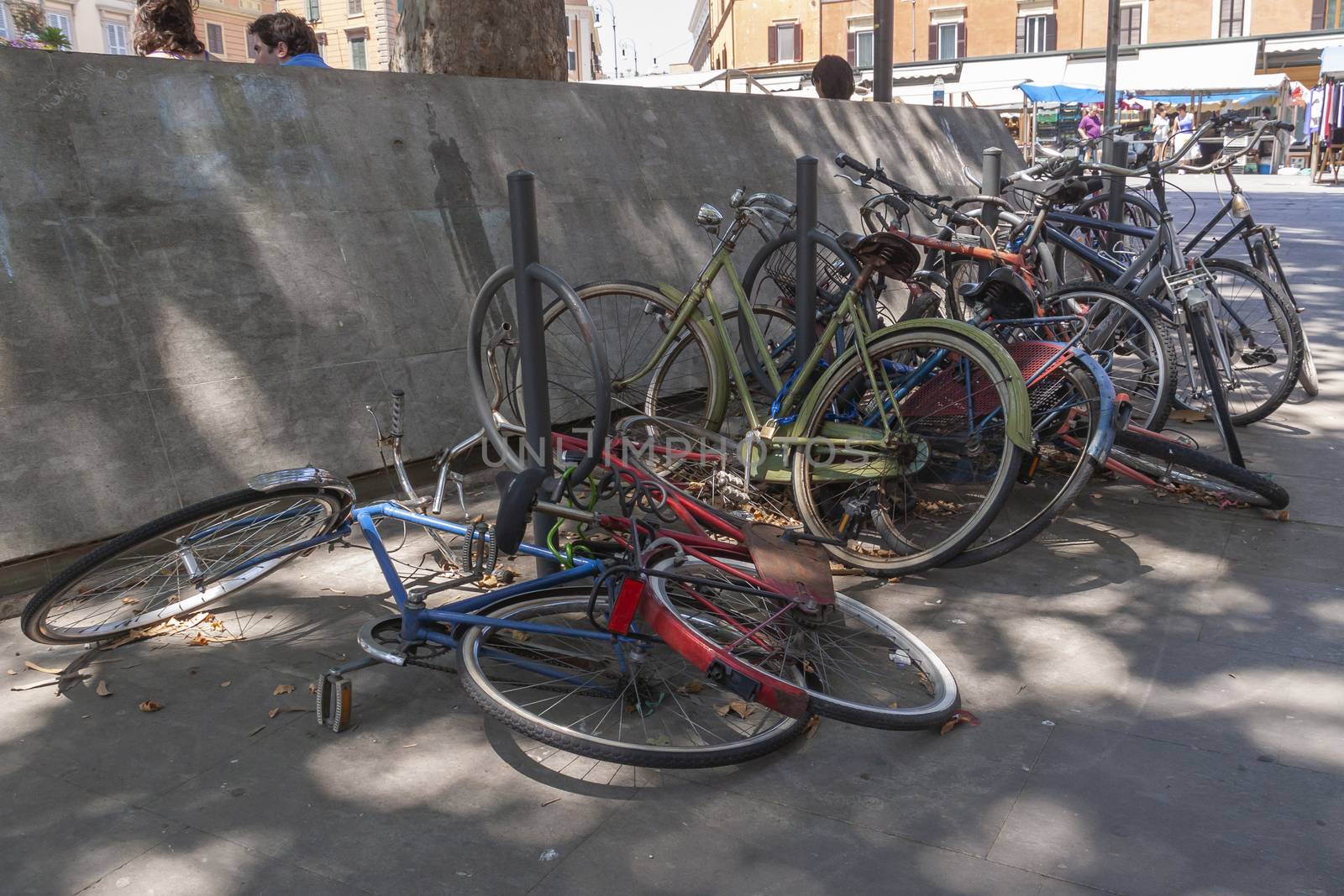 Rome, Italy - June 28, 2010: A lot of bicycles, old, some broken, remain abandoned and rusting in a street in Rome.