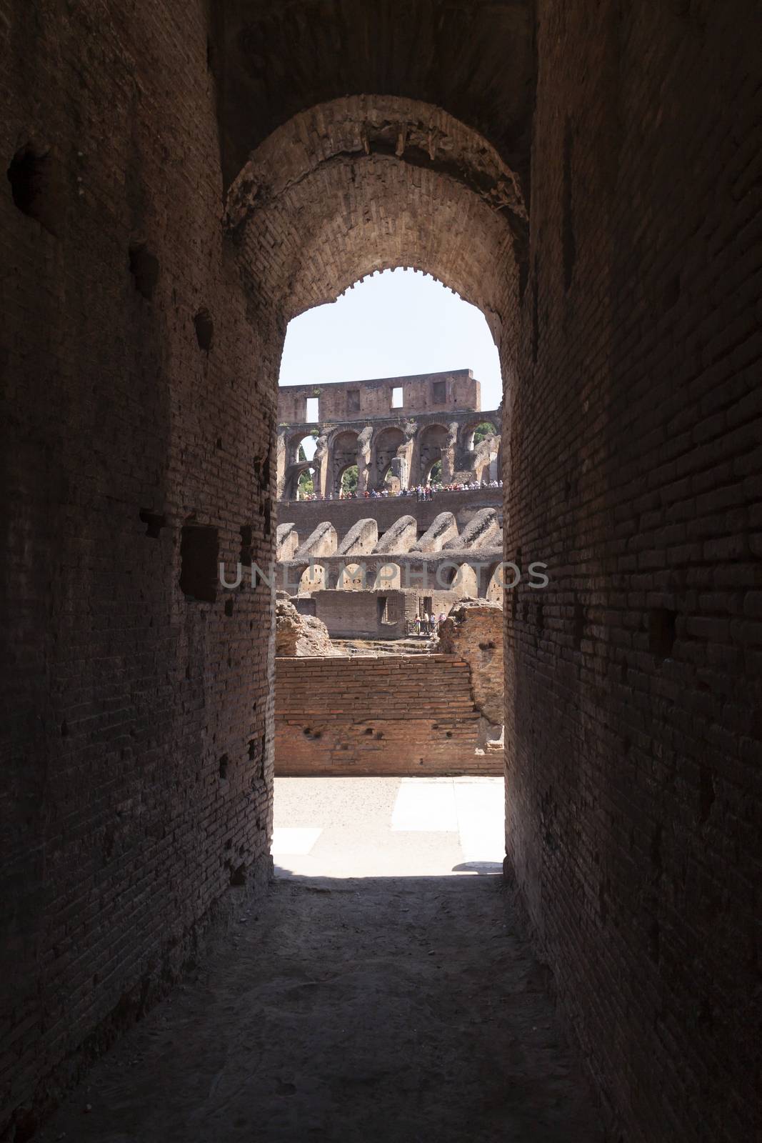 Rome, Italy - June 29, 2010: Rows of tourists, seen in the distance, from one of the exits of the corridors and passages that lead to the arena of the Roman Colosseum.