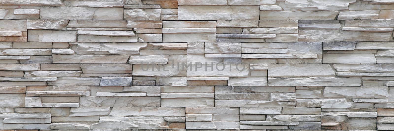 Stone background walls are stacked. Stone cladding background and wallpaper. by Eungsuwat