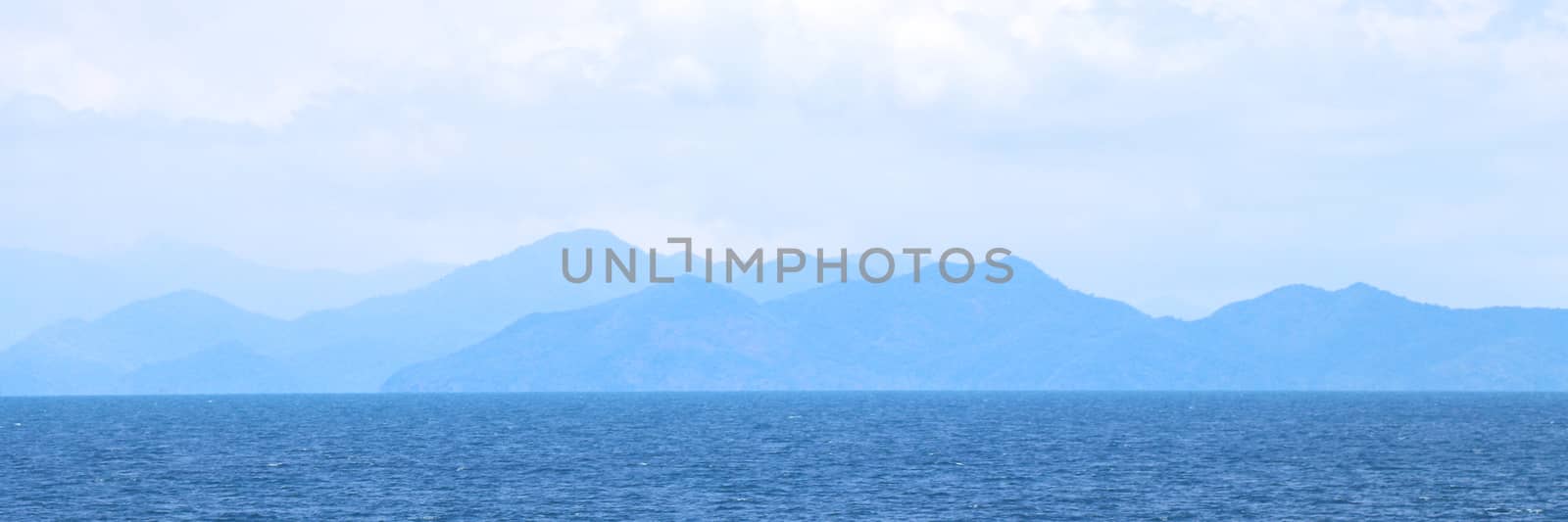 Blue sea with mountains and sky banner background. by Eungsuwat