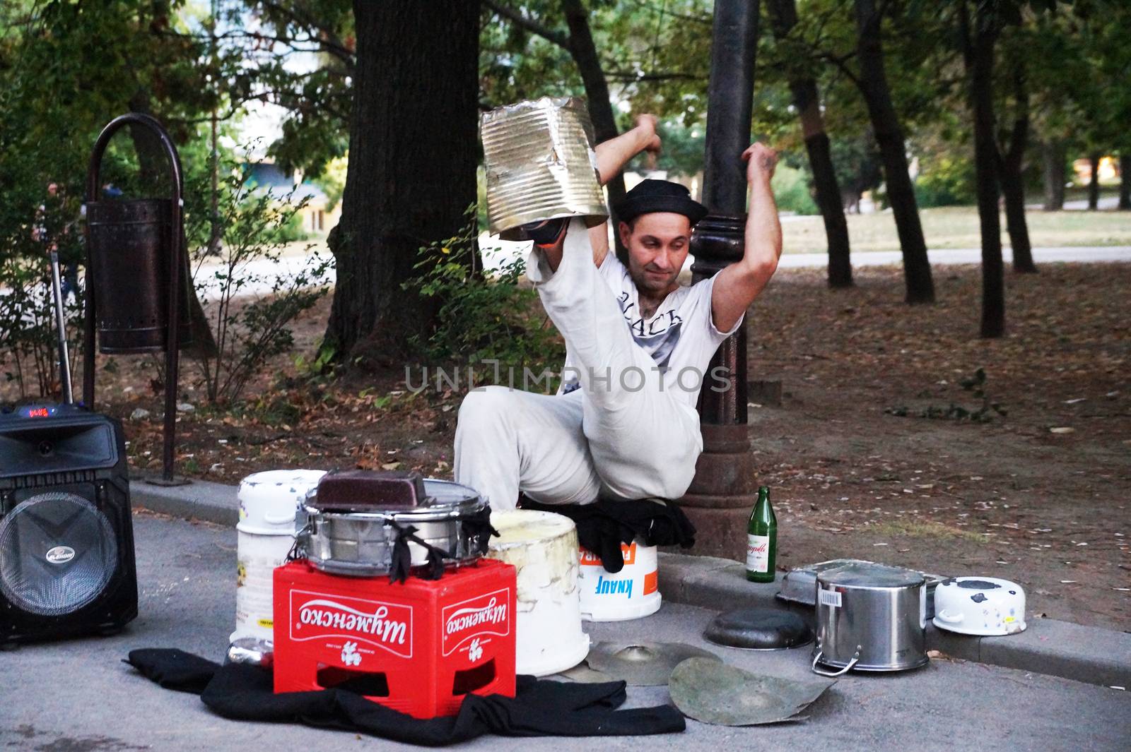 Varna, Bulgaria - September, 06, 2020: street drummer playing in the park with improvised means