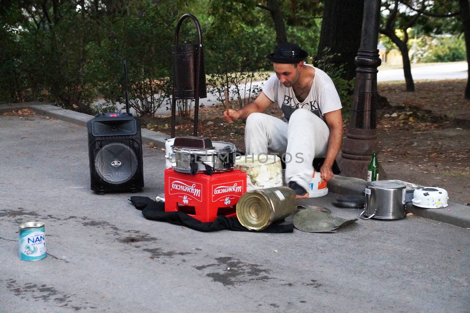 Varna, Bulgaria - September, 06, 2020: street drummer playing in the park with improvised means