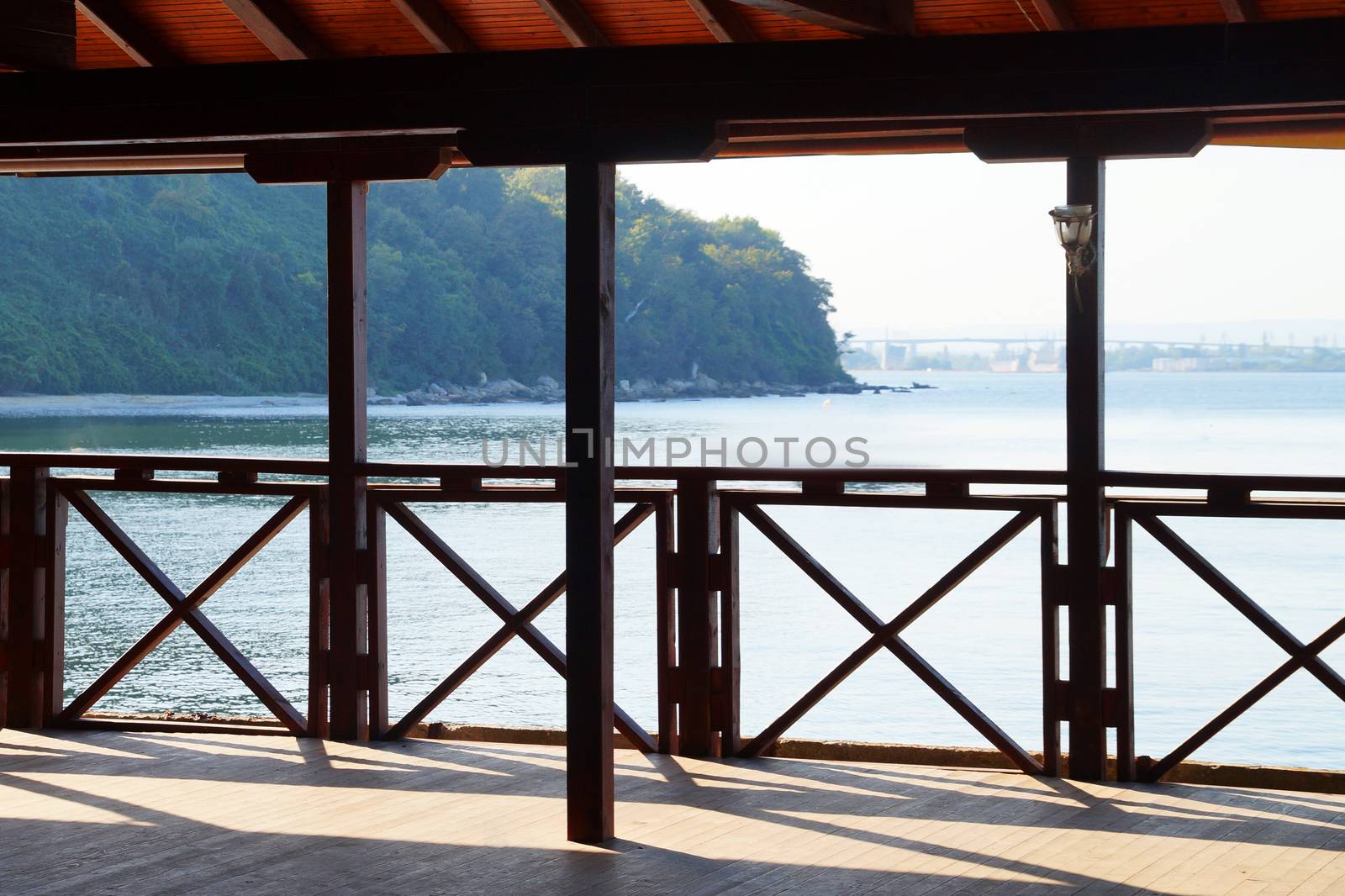 empty terrace with wooden railing on the background of the sea by Annado