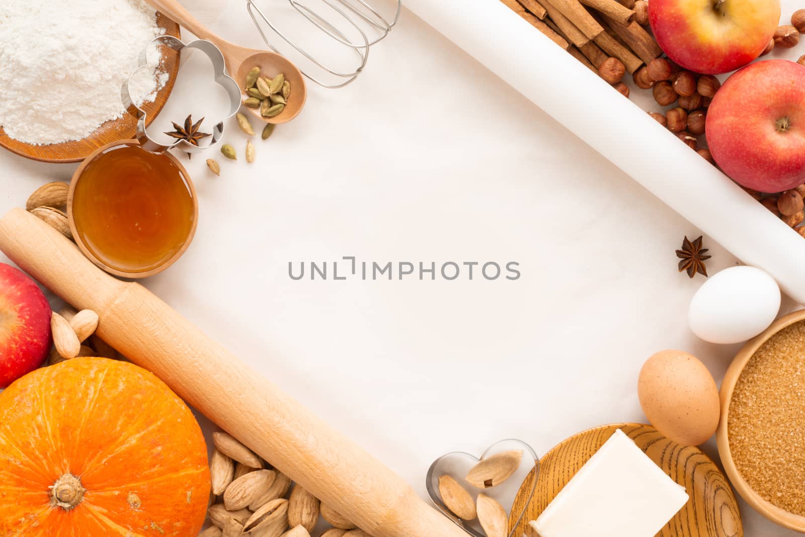 Autumn baking background border frame design with copy space for text. Cooking ingredients pumpkin, apples, wheat, honey butter flour nuts, toning, bright orange colors