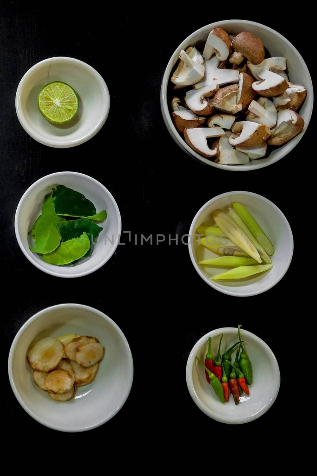 Chili peppers with lime, mint, mushrooms, cucumber, walnut bowl with black background by balage941