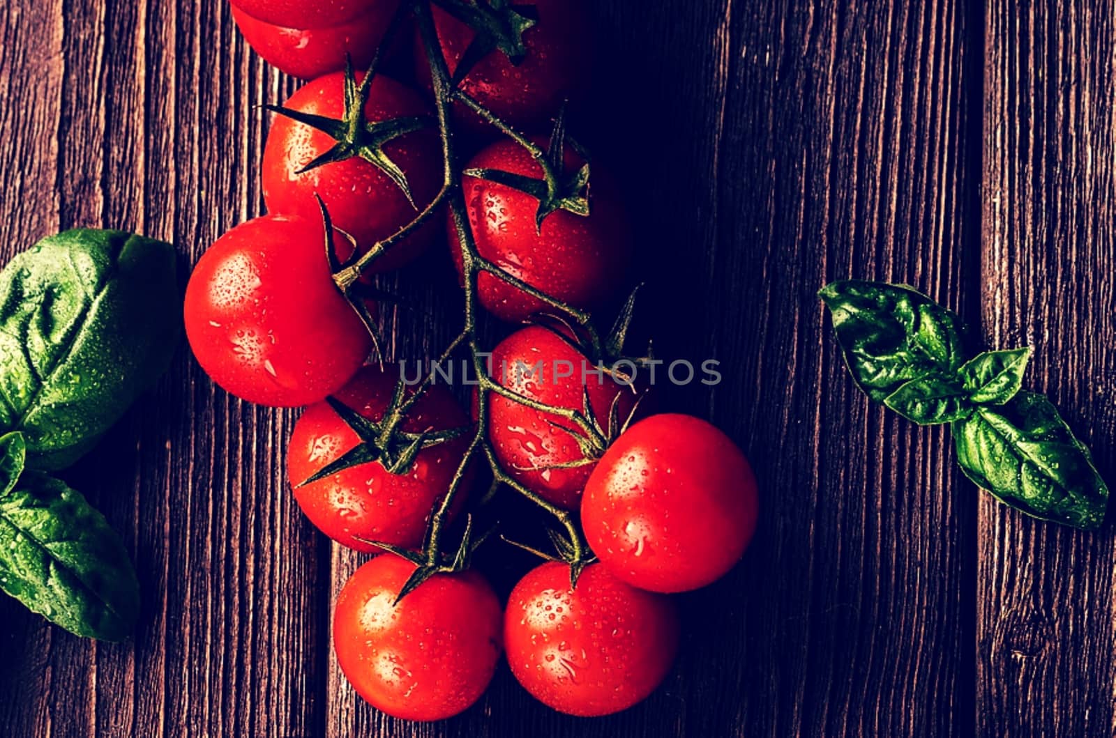 Some tomatoes sitting on top of a wooden table.