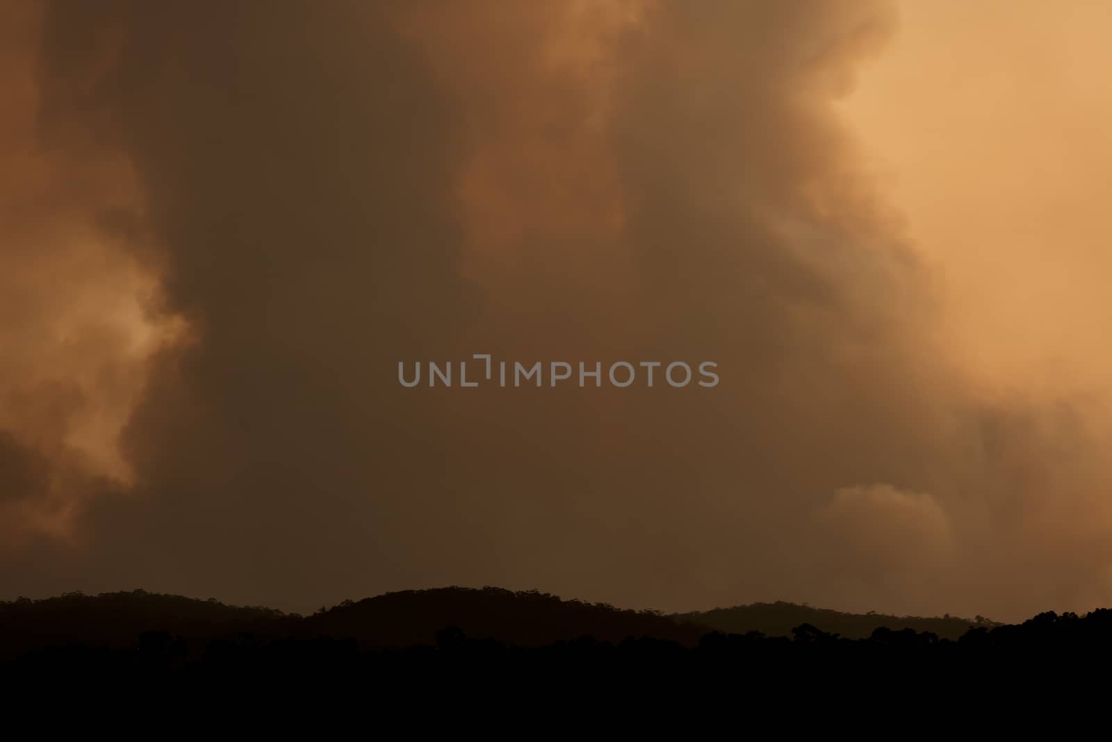 Bush fire smoke at sunset in a valley in The Blue Mountains in Australia