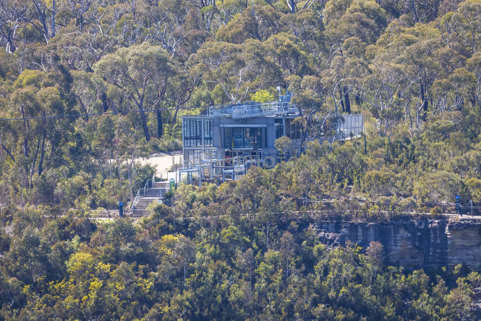 A cable car terminal building amongst trees in a forest by WittkePhotos