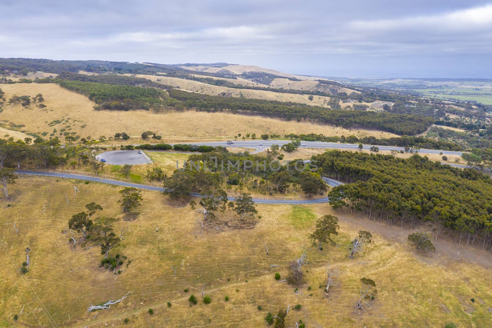 A highway running through rolling green hills in Australia by WittkePhotos