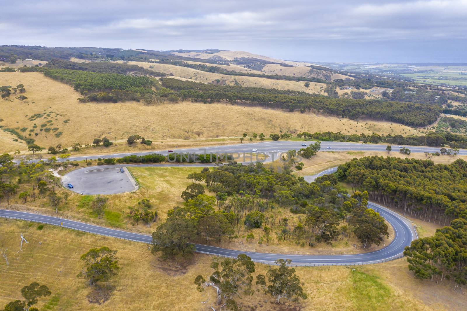 A highway running through rolling green hills in regional Australia