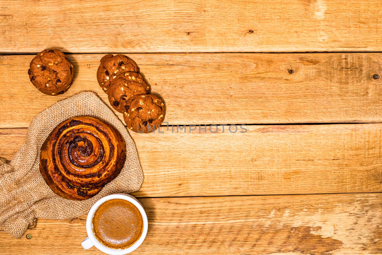 Fresh puff pastry on wooden table. Coffee, food and breakfast co by vladispas