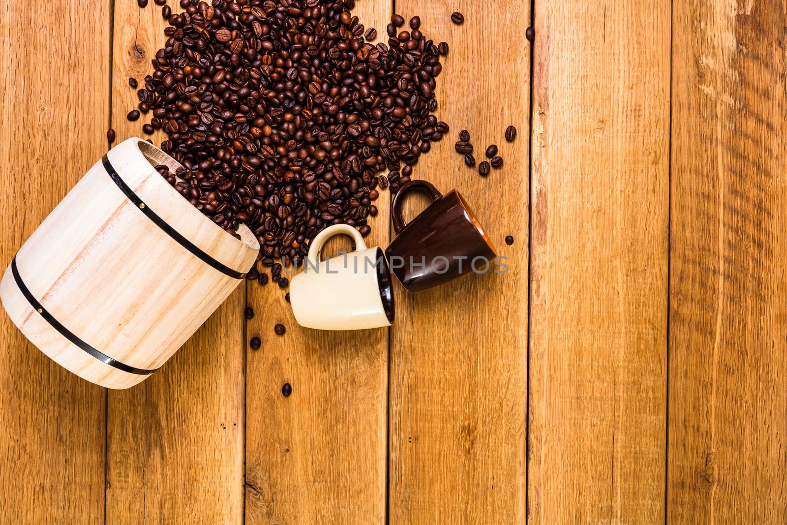 Cup of coffee, roasted coffee beans on wooden background, coffee wooden barrel top view, copy space for text, close up coffee photo