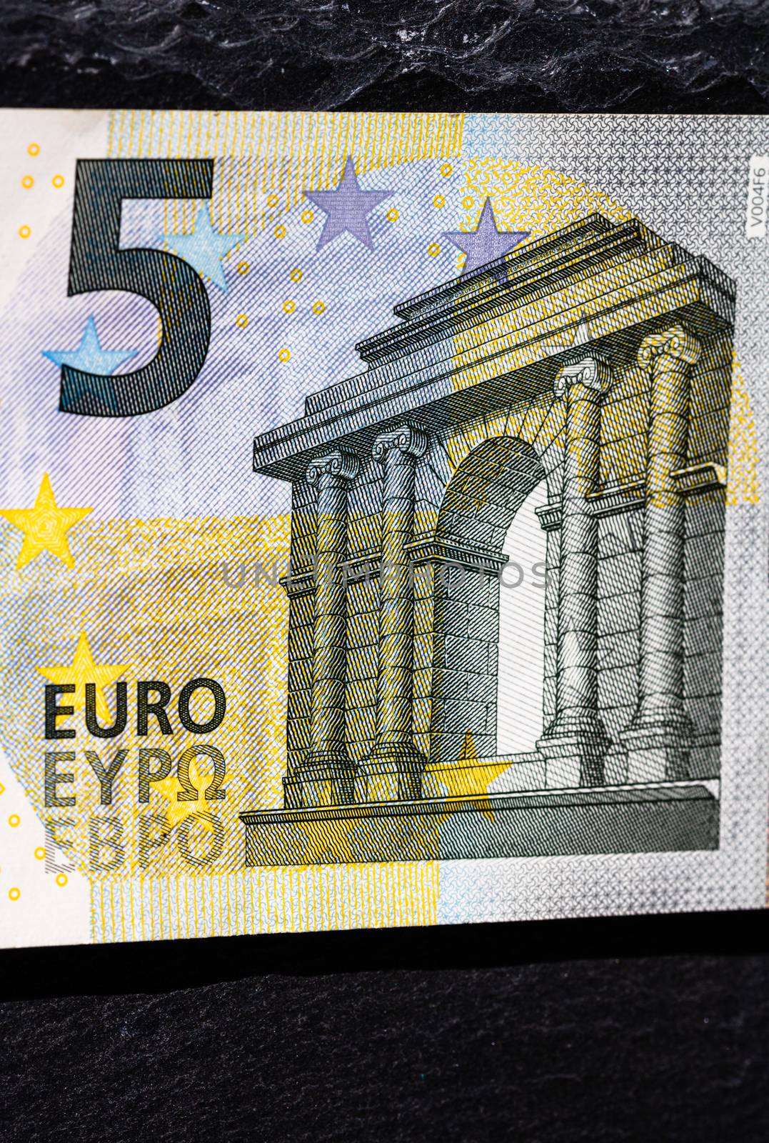 Selective focus on detail of euro banknotes. Close up macro detail of money banknotes, 5 euro isolated. World money concept, inflation and economy concept