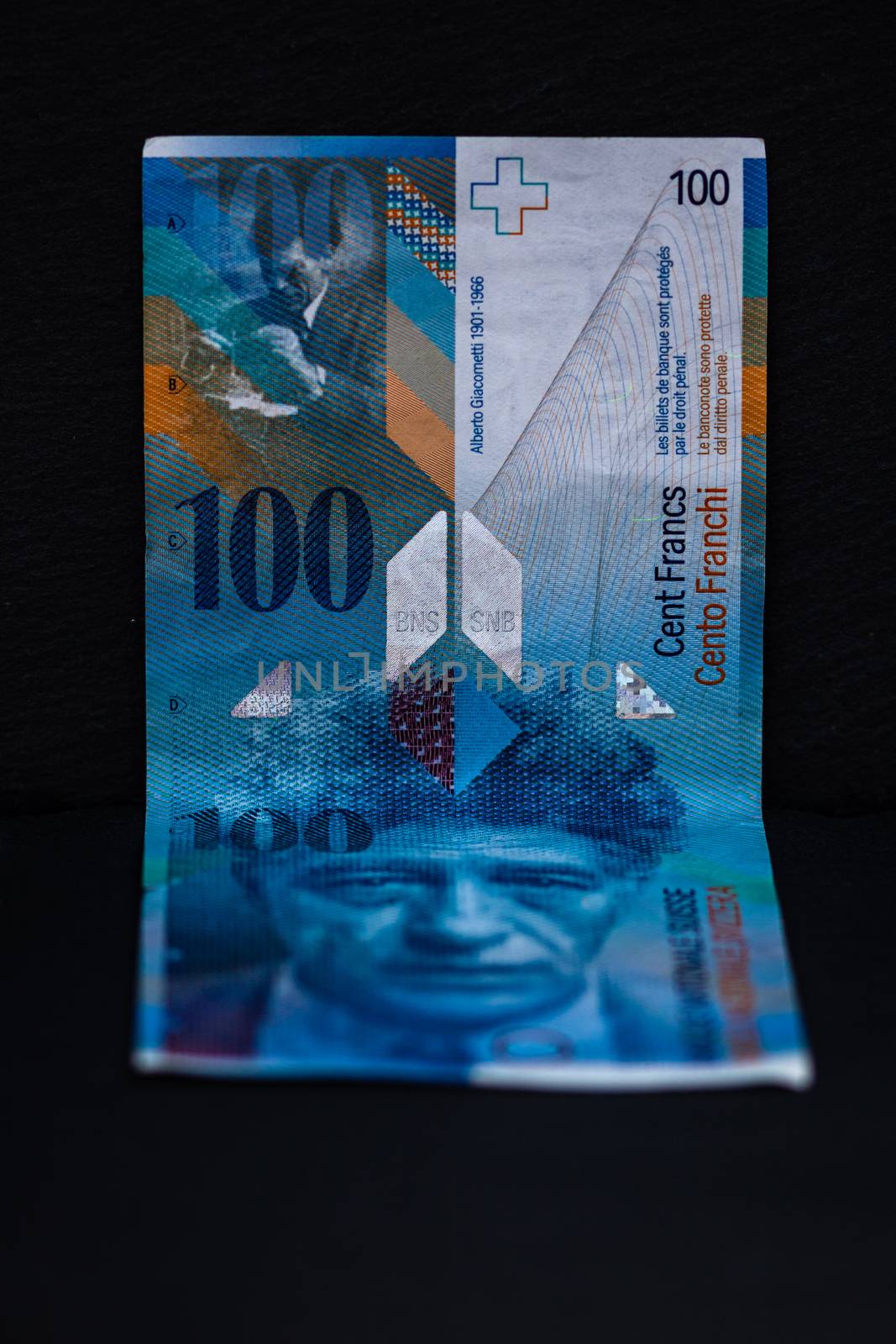 Selective focus on detail of 100 swiss franc banknote. Close up macro detail of money banknotes, swiss franc isolated. World money concept, inflation and economy concept