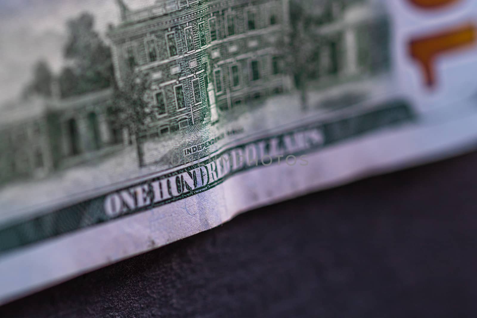 Selective focus on detail of 100 dollars banknote. Close up macro detail of money banknotes, dollars isolated. World money concept, inflation and economy concept