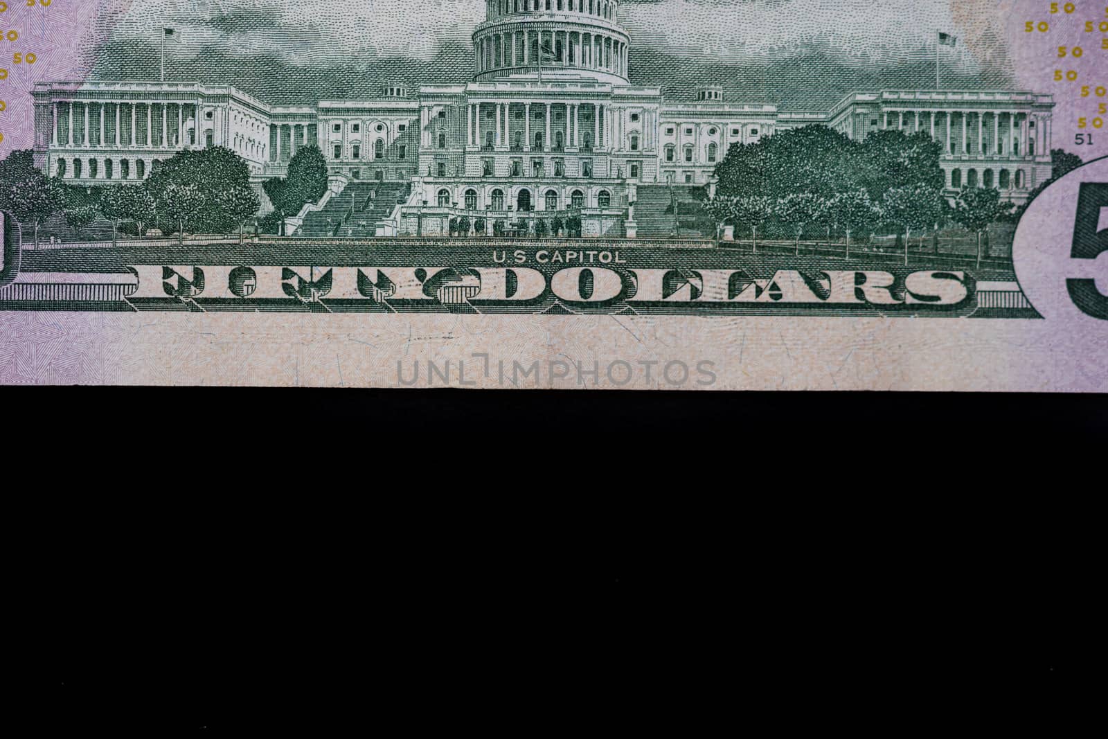 Selective focus on detail of 50 dollars banknote. Close up macro by vladispas