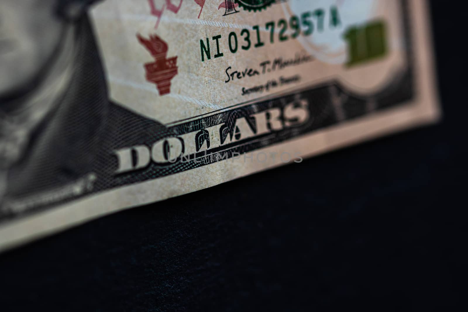 Selective focus on detail of 10 dollars banknote. Close up macro detail of money banknotes, dollars isolated. World money concept, inflation and economy concept
