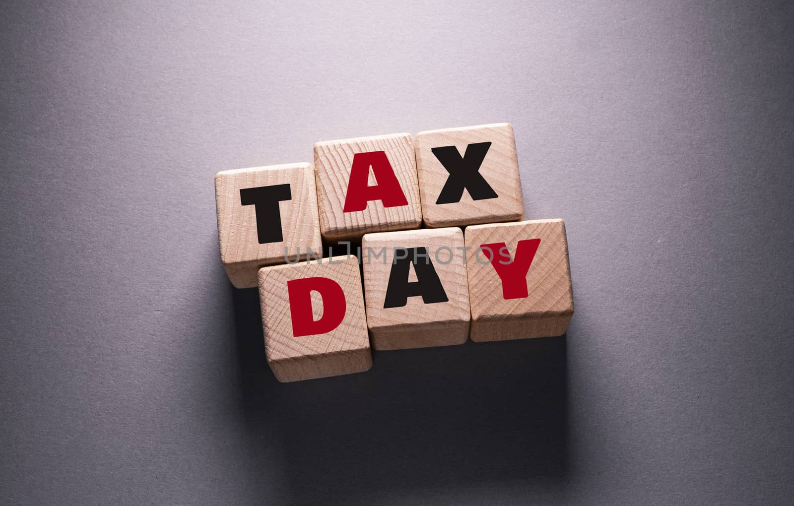 Tax Day Word with Wooden Cubes by Jievani
