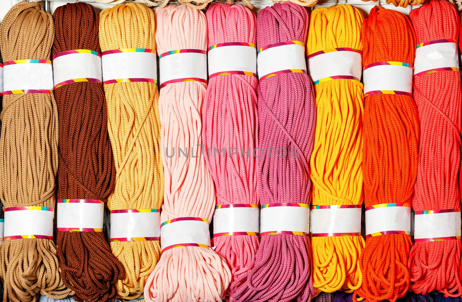 Skeins of polyester cord of various bright colors of hot shades. by Sergii