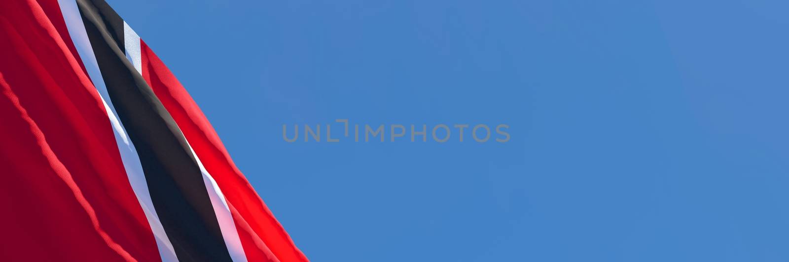 3D rendering of the national flag of Trinidad and Tobago waving in the wind against a blue sky