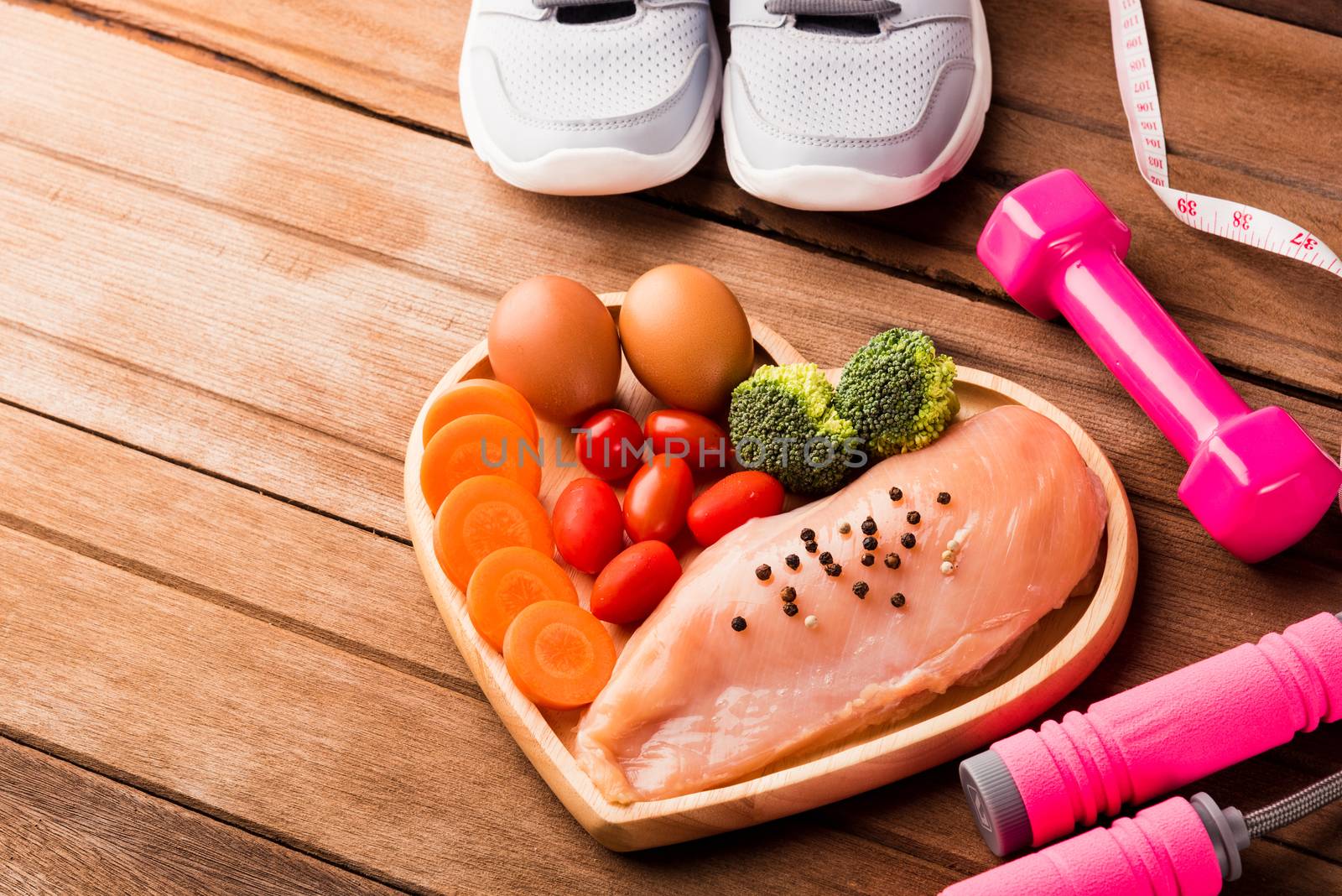 Raw chicken breasts fillets in heart plate wood and sport or ath by Sorapop