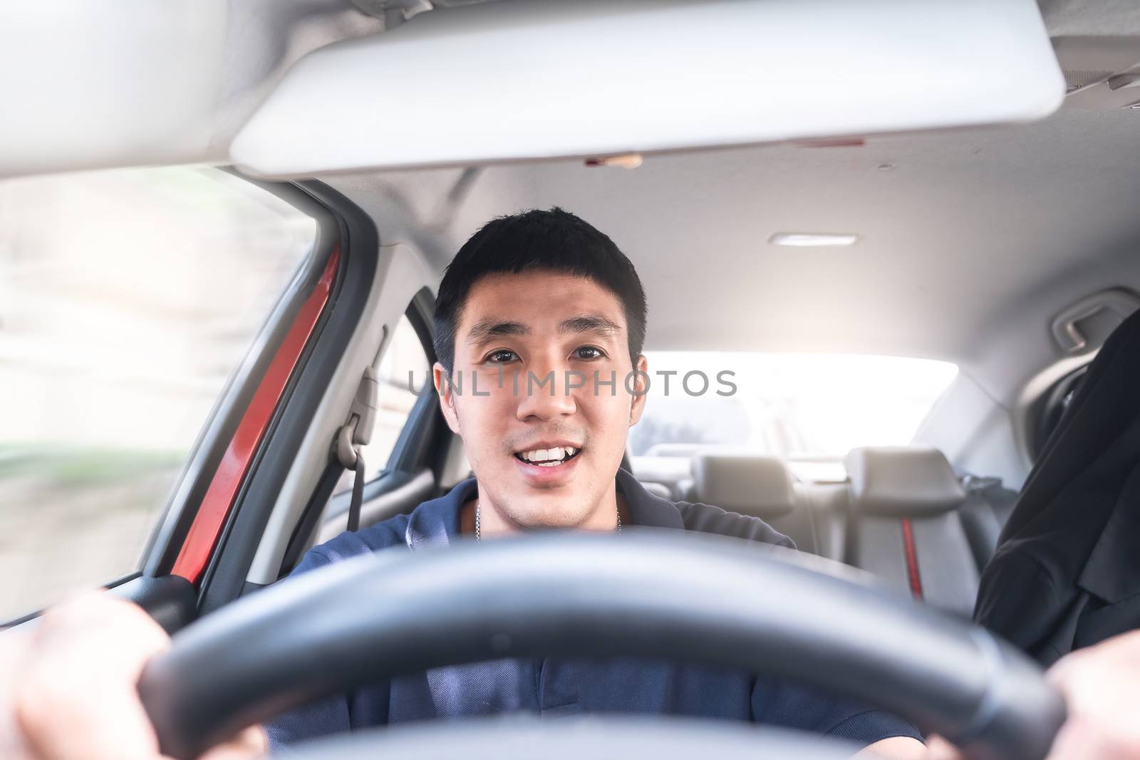 Young Asian man driving car He sometimes smile so happy drive To travel during the outbreak coronavirus covid-19