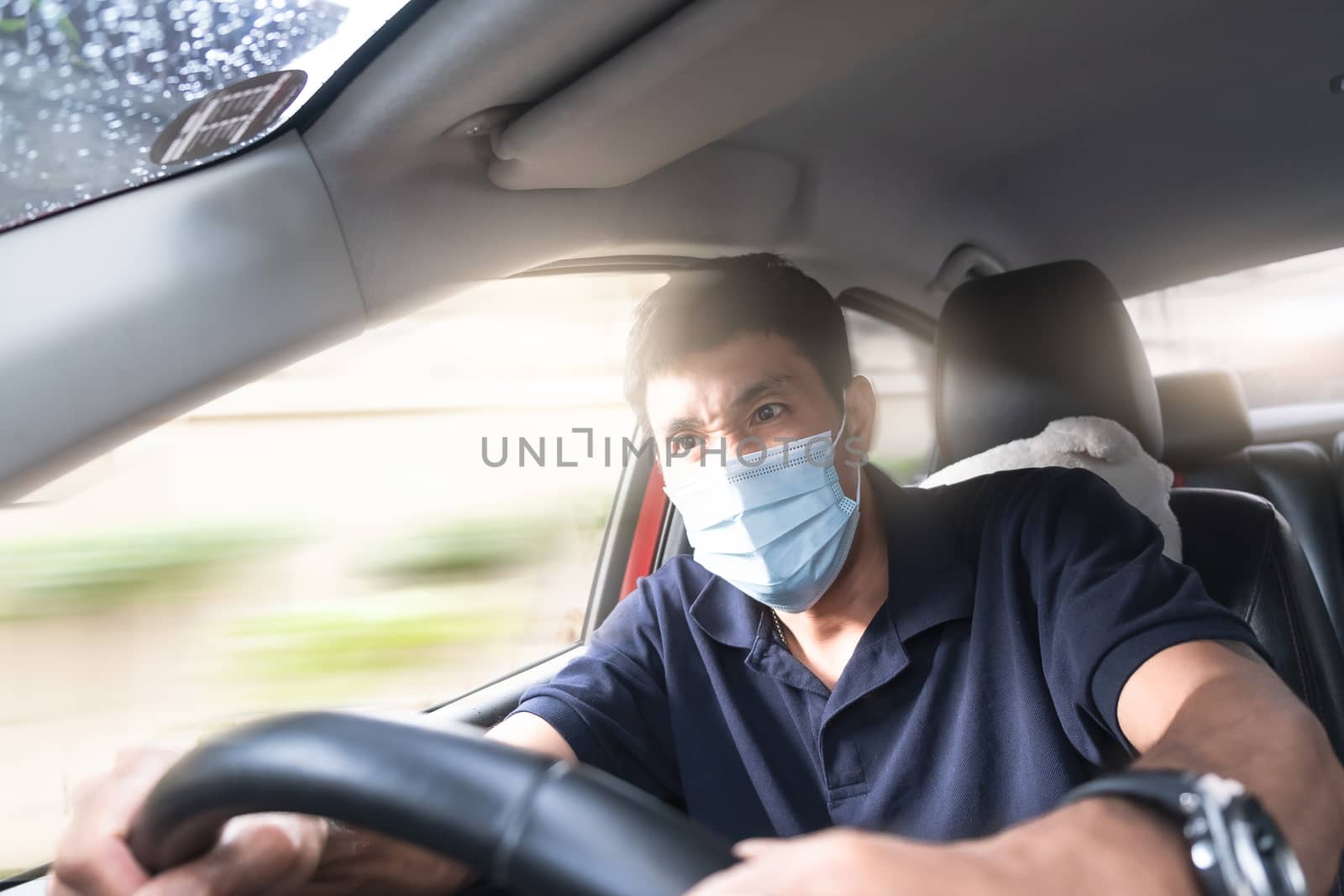 Young Asian man wearing surgical mask driving car so panic shock by oatzpenzstudio