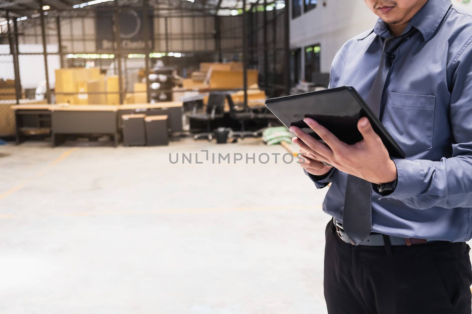 Asian business man writing clipboard on blurred background.metaphor to business in development, success, entrepreneur or employment and advertising logistic image