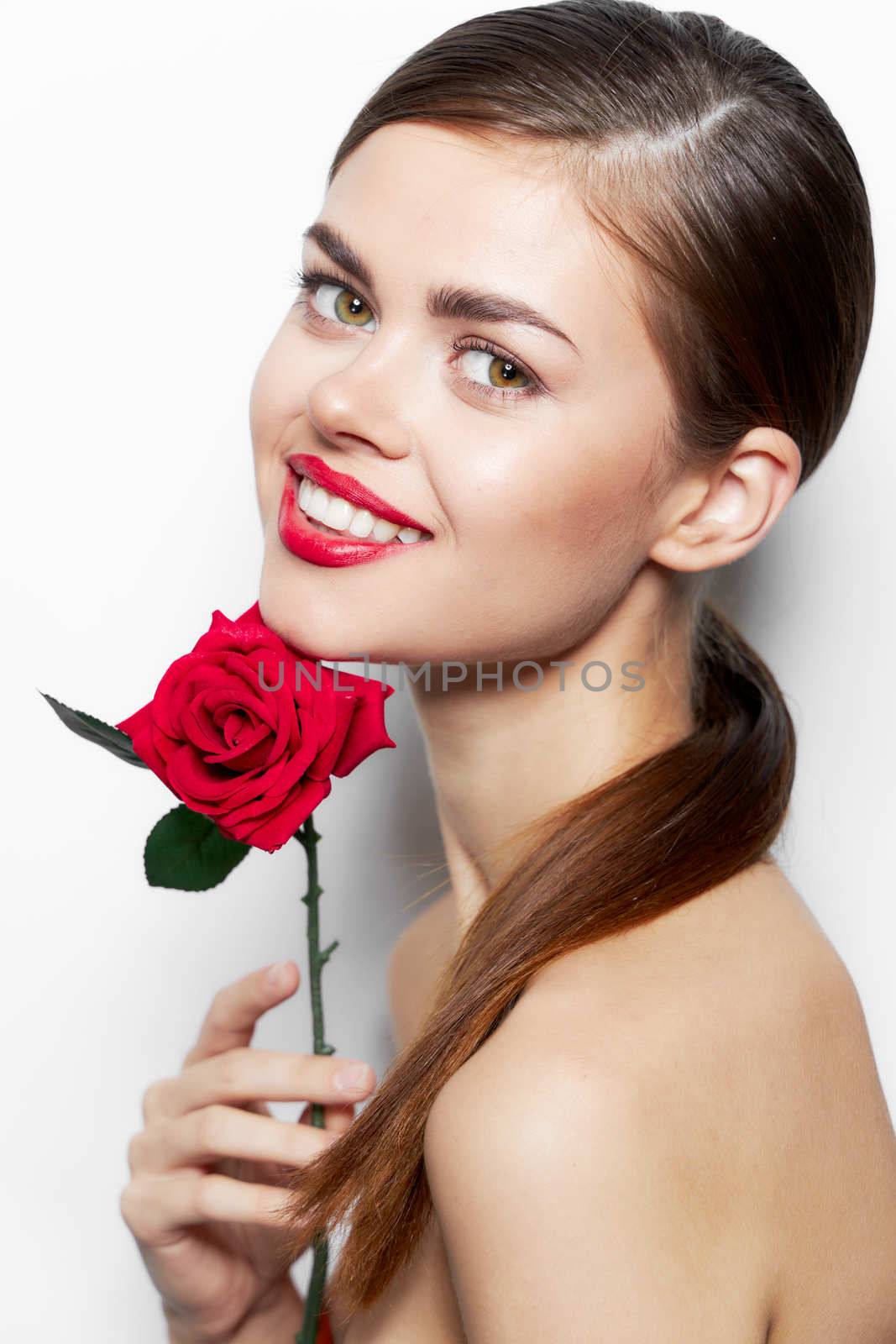 Lady with rose bright Smile flower near the face makeup background