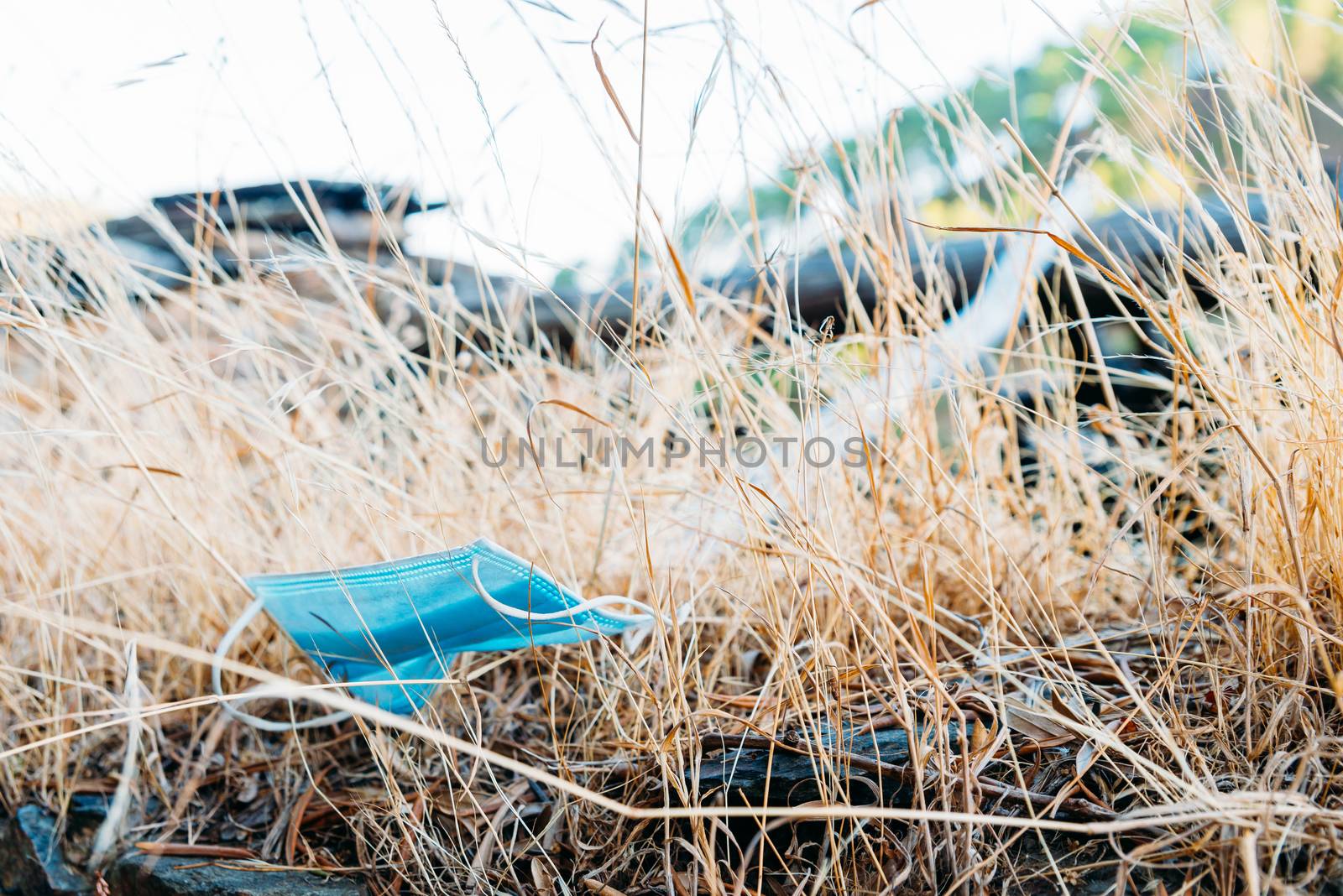 A discarded face mask lying on the ground.