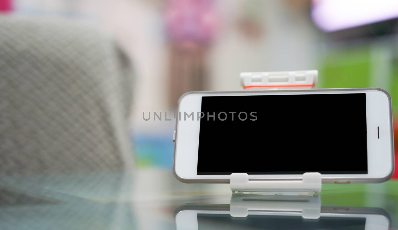 mockup of screen of smartphone on docking on table