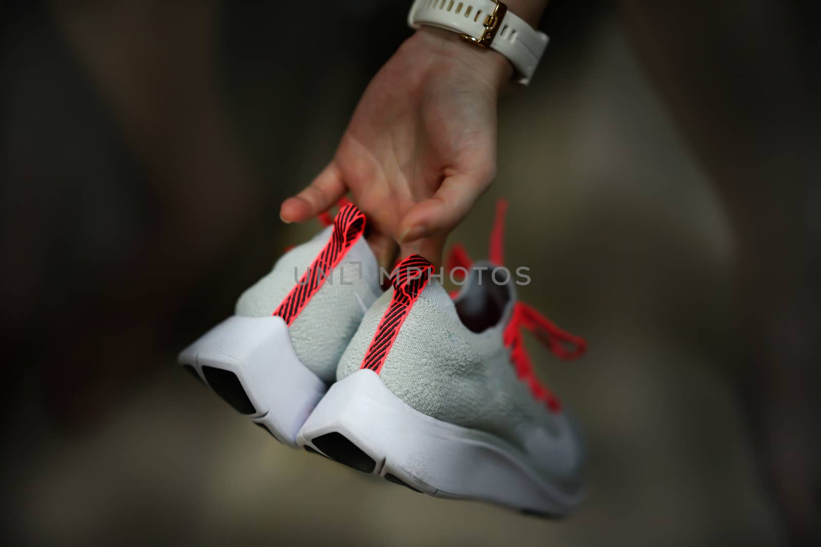hand hold sport run footwear shoe on back side vie