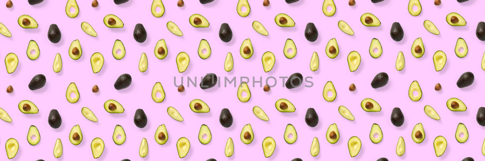 Avocado banner. Background made from isolated Avocado pieces on pink background. Flat lay of fresh ripe avocados and avacado pieces. by PhotoTime