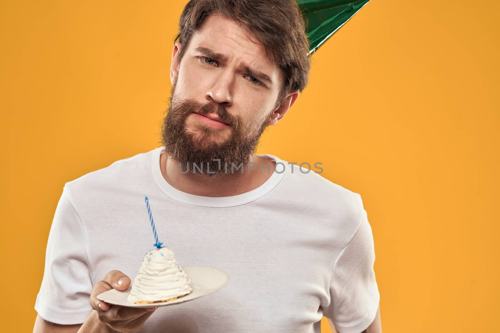 A man in a cap on a yellow background holiday birthday. High quality photo