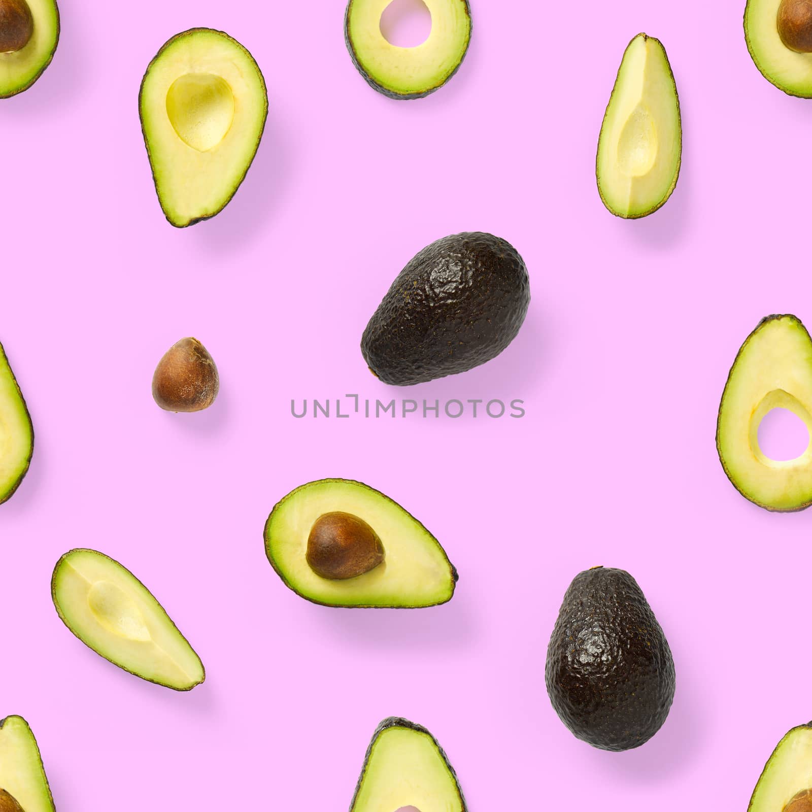Seamless pattern with avocado slices. Tropical fruit abstract background. Avocado pattern the pink background