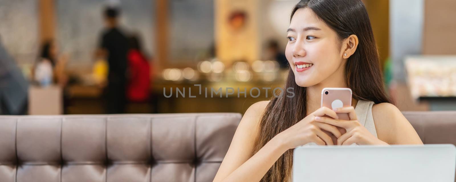 Banner, web page or cover template of Asian young female holding a cup of coffee in modern coffee shop or coworking space beside window mirror,japanese,chinese,Korean lifestyle and daily life concept