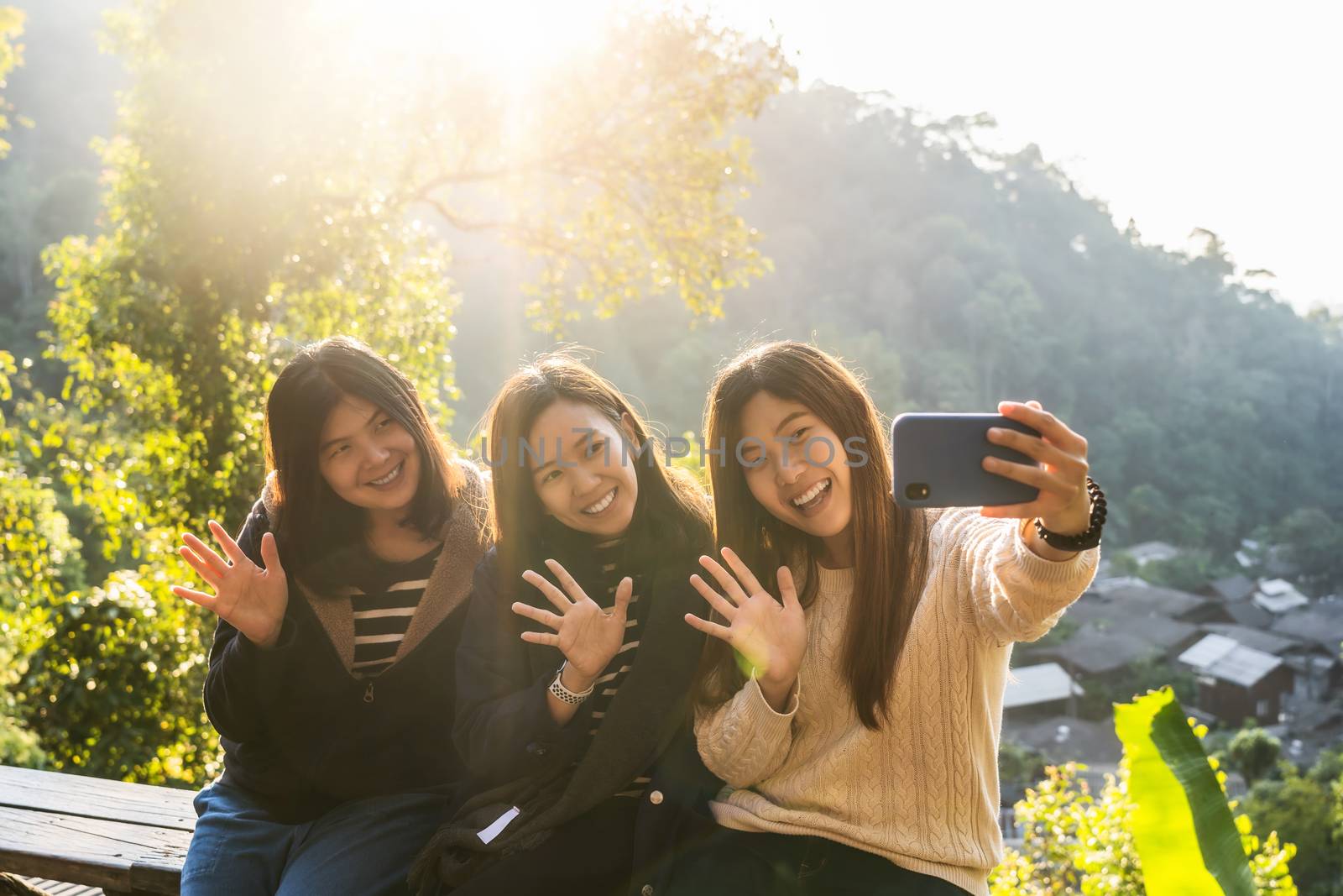 Three asian happiness women using smart mobile phone for selfie  by Tzido
