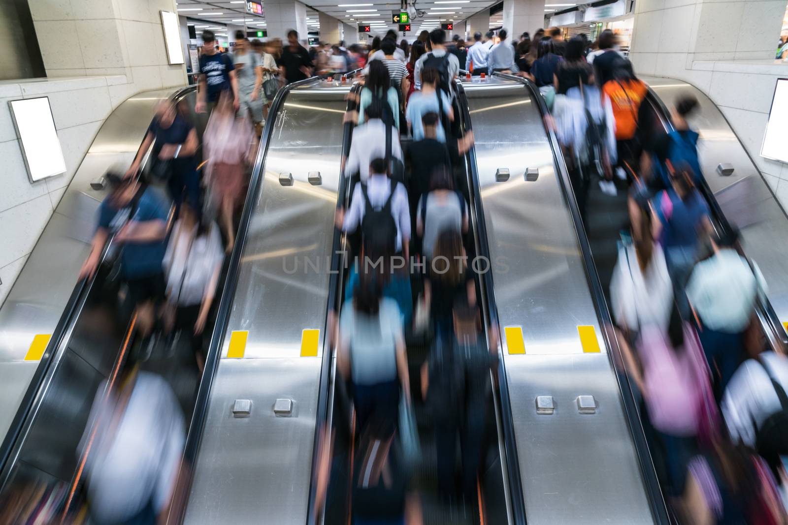 Crowd of Pedestrians Unrecognizable walking in escalator in rush hour morning before working time in subway transportation hub, Hong Kong, Central District, fast moving and business people concept