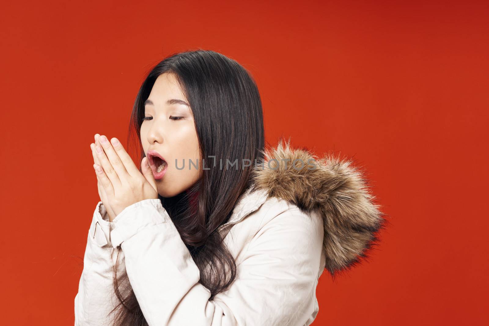 woman asian appearance winter jacket cool lifestyle cropped view red background