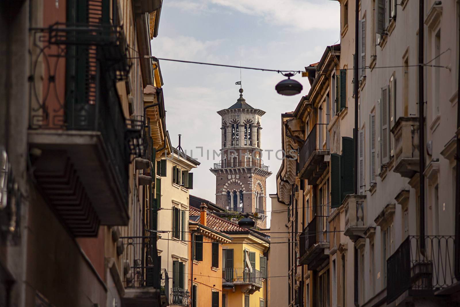 Verona Tower seen amidst historic houses and buildings