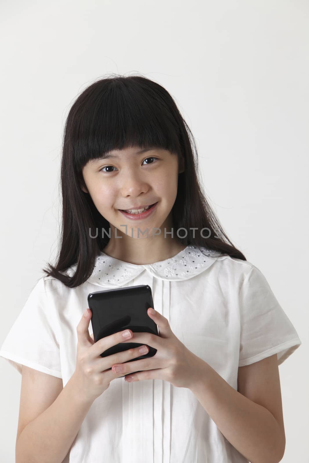 chinese girl sending text message with mobile phone