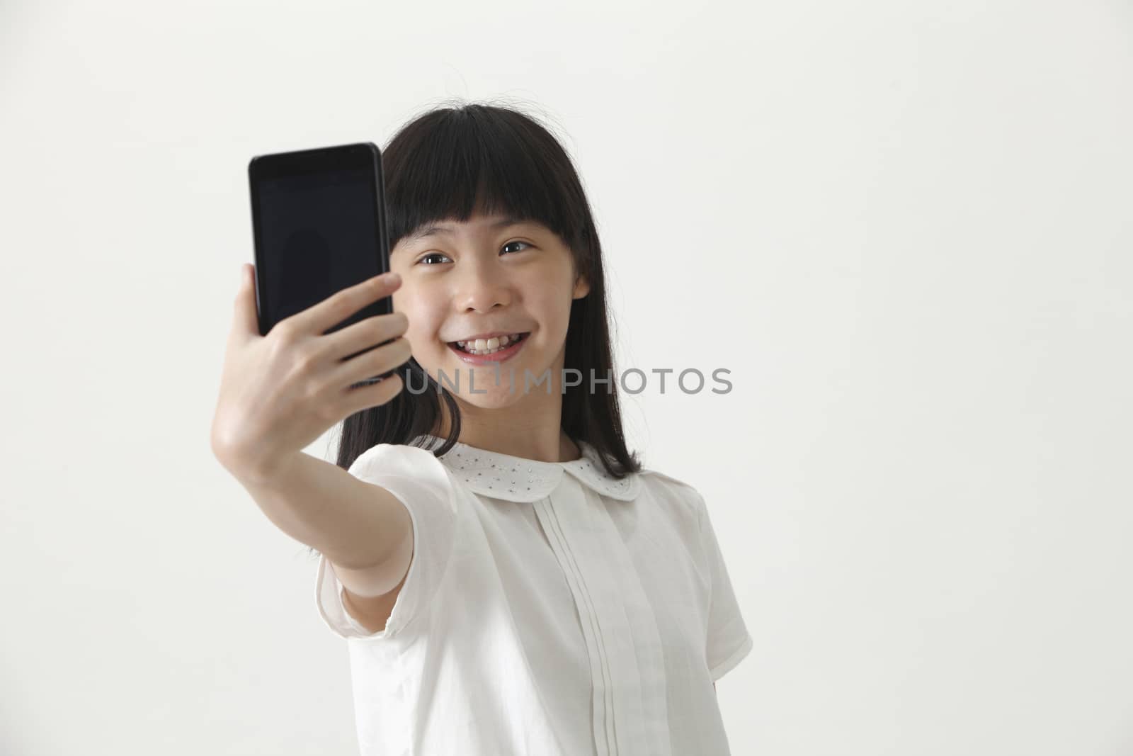 Front view chinese girl self portrait with smart phone