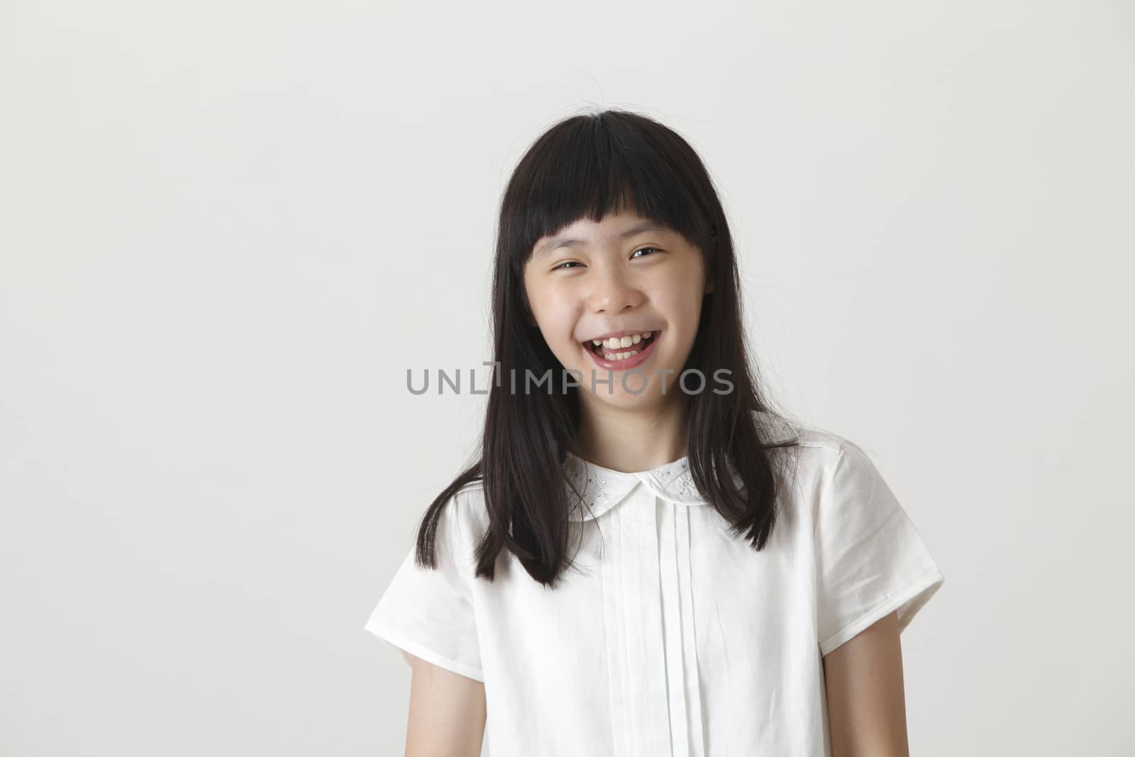portrait of chinese girl laughing looking at camera