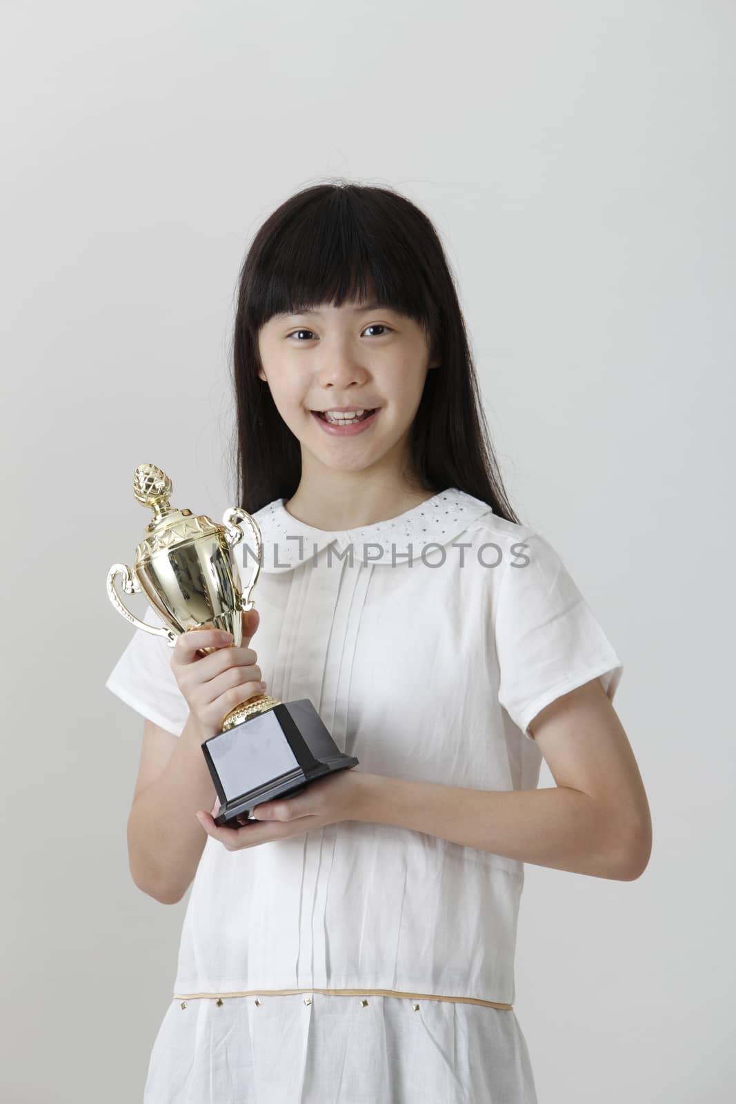 chinese girl holding trophy with both hands