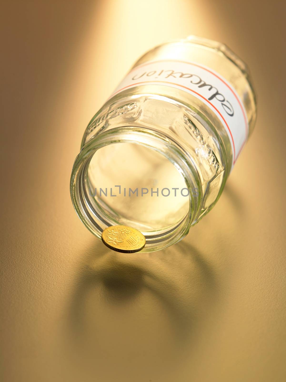 the only coin resting on the jar labelled education