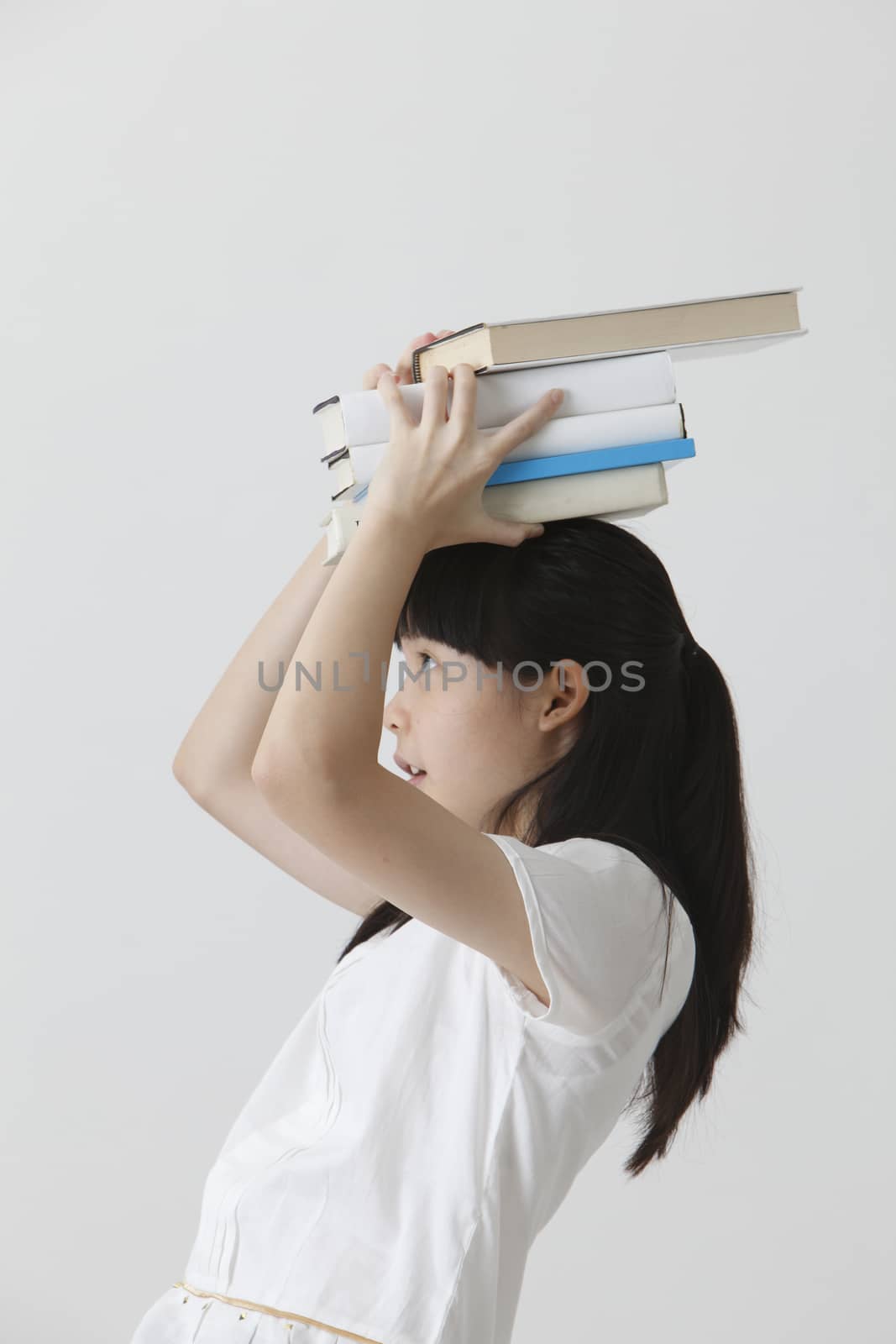 chinese girl balancing with books