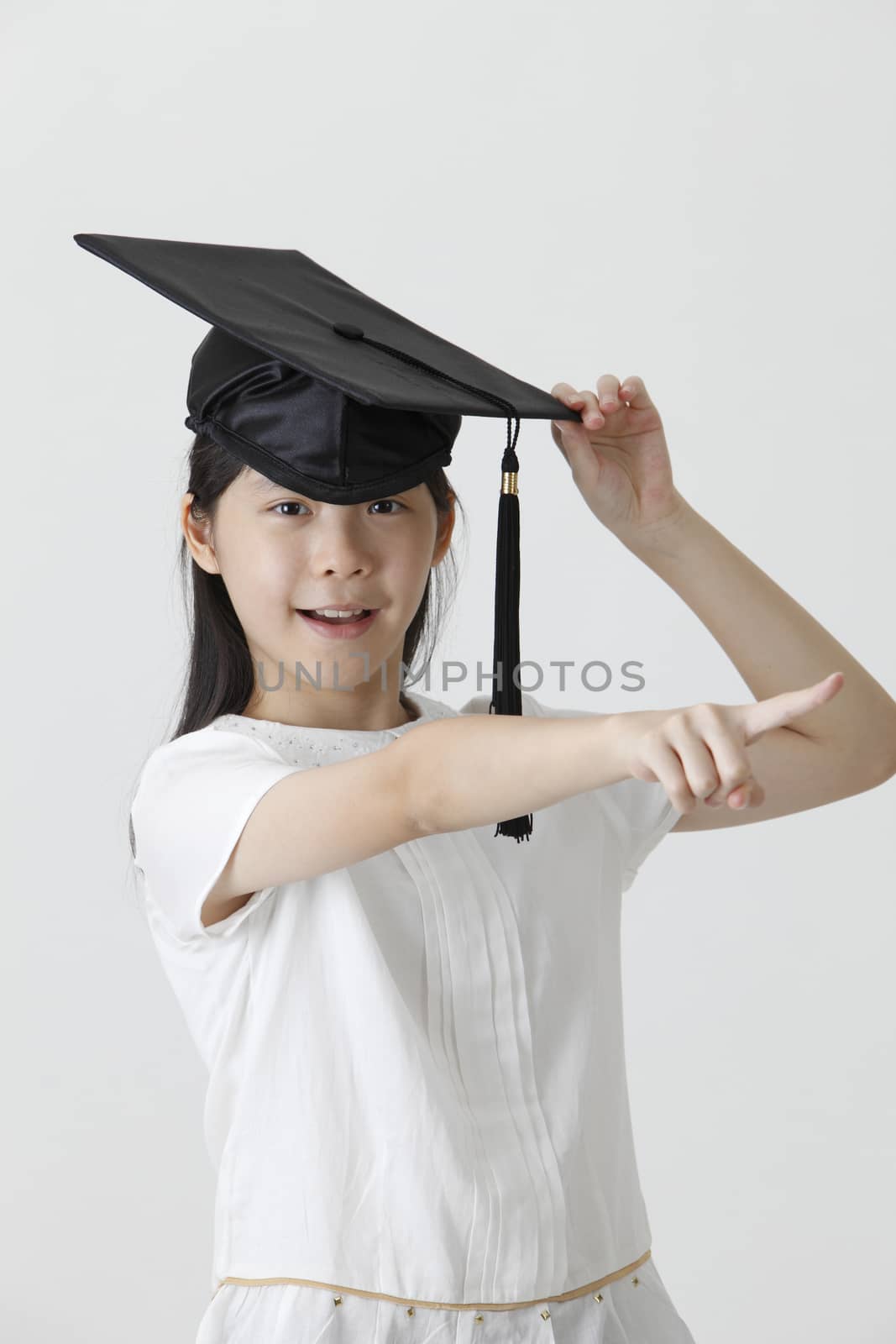 girl with the mortar board pointing