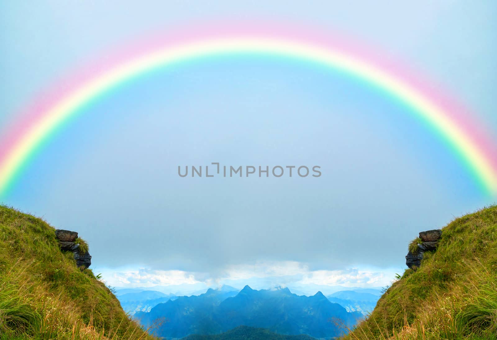 Two mountain peaks with a rainbow in the middle