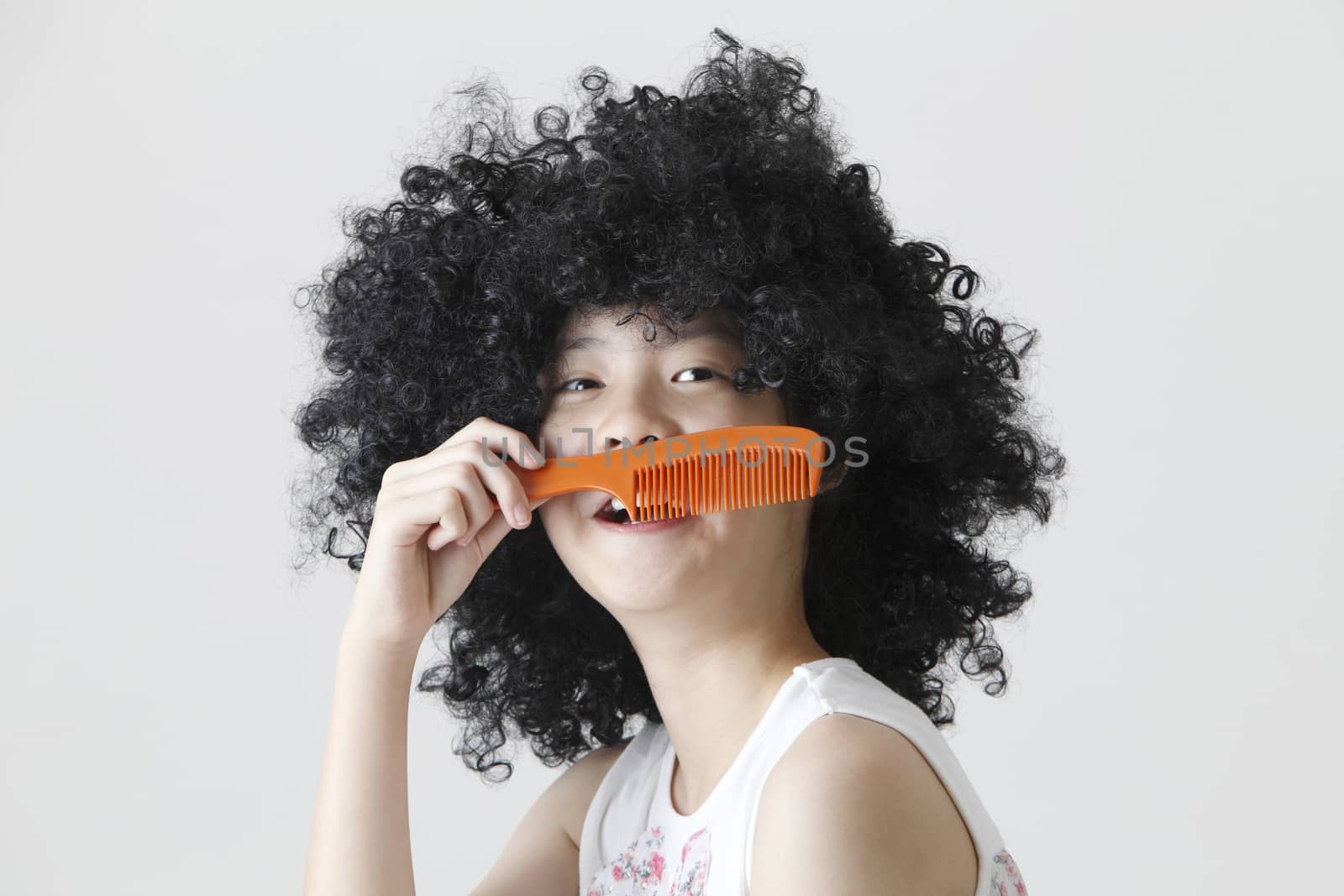 chinese girl wearing a big black wig holding a comb